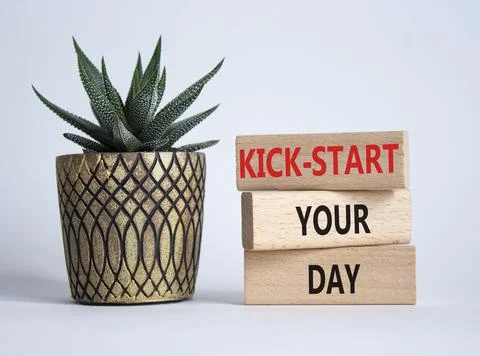 Kick-start your day team symbol. Wooden blocks with words Kick-start your d.. Fotos de archivo