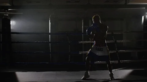 Kickbox fighter shadow boxing in the ring. The athlete fights with his shadow Stock Footage
