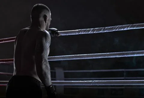 Kickboxer climbs into the ring. View from the back. Sports competitions. Fi.. Stock Photos