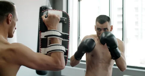 Kickboxer does roundhouse kick in slow motion, kickboxers are training in the Stock Footage 160667234