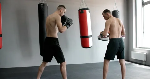 The kickboxer is practising his middle kick with trainer in slow motion in the Stock Footage 161274546
