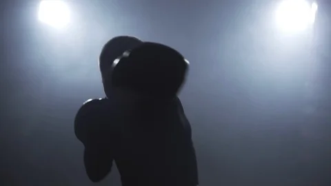 Kickboxer training in low light gym. Sportsman boxing in camera Video stock 109792364