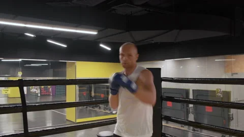 Kickboxer training in low light gym. Sportsman boxing in camera Stock Footage 141986522