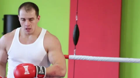 Kickboxer is working out blows in the ring closeup Stock Footage 58054994