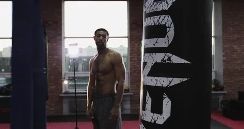 Kickboxing black man training punching bag in fitness studio. Stock Footage 101523396