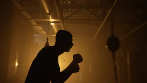 Kickboxing, man fighter training his punches, beating a punching bag training Stock Footage 204846898