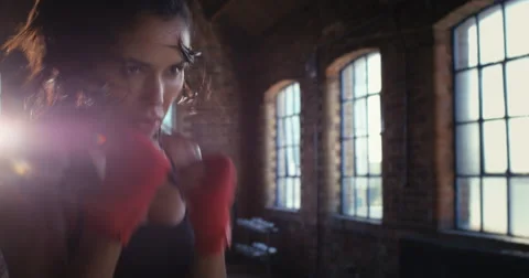 Kickboxing woman training punching bag in fitness studio Stock Footage