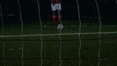 Kicker striking ball; goalkeeper diving, saving ball to prevent goal, net tech Stock Footage 330717751
