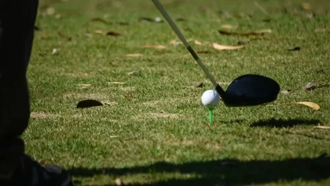 Kicking a golf ball on the grass Stock Footage 146487080