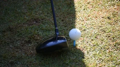 Kicking a golf ball on the grass Stock Footage 146525093
