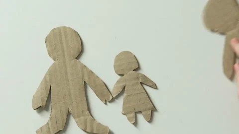 Kid adding figure of mother and toy heart to paper family dreaming about parents Stock Footage 101585192