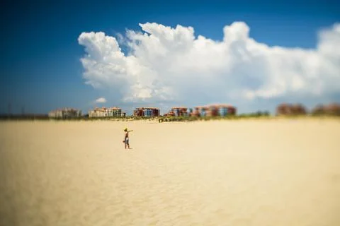 A kid alone on the beach, Ayamonte, Spain A tilted lens was used for a sha Stock Photos
