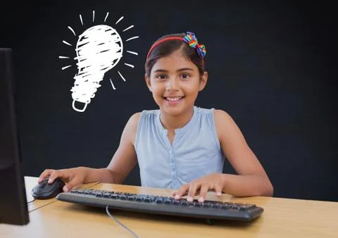 Kid and blackboard with lightbulb using computer against a black background 스톡 사진