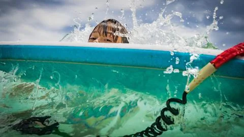 Kid and bodyboard in the ocean Stock Photos