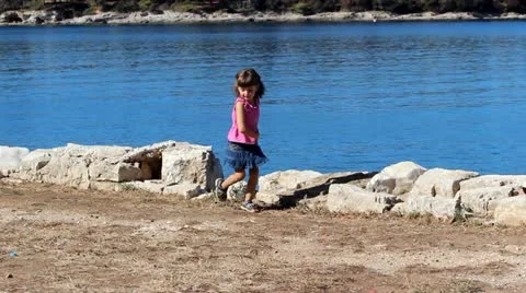 Kid and pebbles Stock Footage 20522860