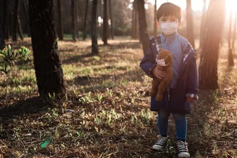 Kid and teddy bear using air masks Stock Photos