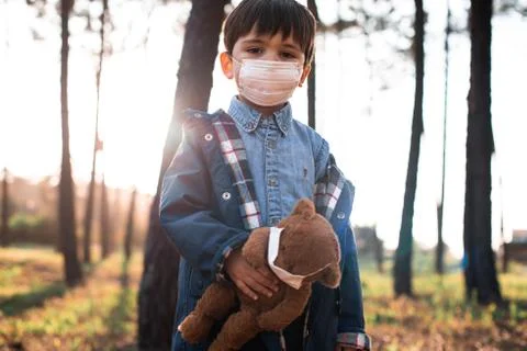 Kid and teddy bear using air masks Stock Photos