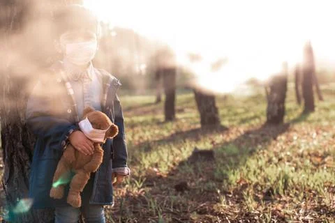 Kid and teddy bear using air masks Stock Photos