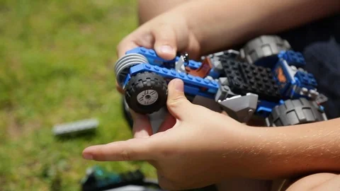 Kid assembling a LEGO toy car Video stock 119200809