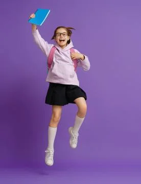 Kid with backpack on color background. Stock Photos