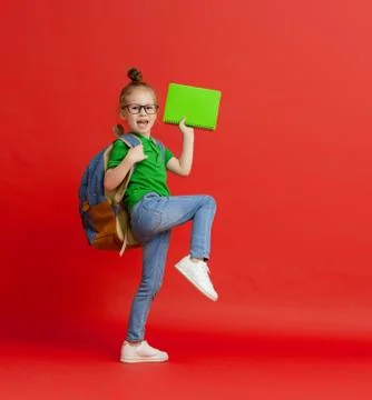Kid with backpack on color background. Stock Photos
