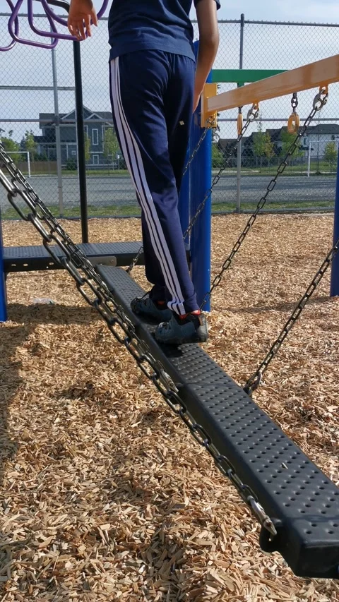 A Kid Balancing in a Hanging Beam Stock Footage 326081070