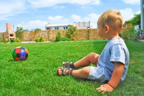 The kid with the ball on the grass Stock Photos