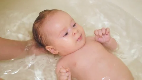 Kid is bathing in bathroom and laughing. Stock Footage 79959645
