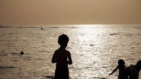 Kid at beach playing with water Stock Footage 74179655