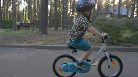 Kid on bike wearing helmet safety concept Stock Footage