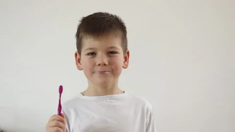Kid boy brushing his teeth using tooth brush and oral paste, cleaning teeth. Stock Footage 169751468