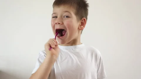 Kid boy brushing his teeth using tooth brush and oral paste, cleaning teeth. Stock Footage 169751682