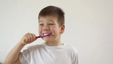 Kid boy brushing his teeth using tooth brush and oral paste, cleaning teeth. Stock Footage 169751731