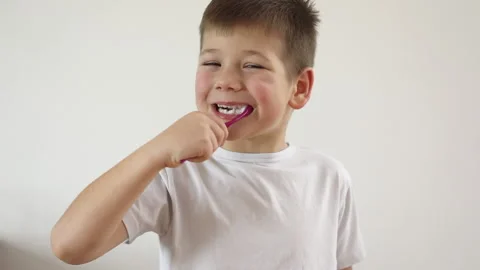 Kid boy brushing his teeth using tooth brush and oral paste, cleaning teeth. Stock Footage 169751774