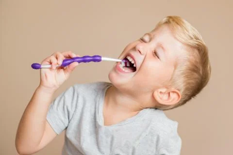 Kid boy brushing teeth Photos