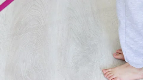Kid boy cleaning the laminate gray floor with green wet mop Stock-Footage 210222159