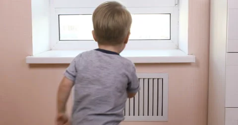 Kid boy climbs on the windowsill  Stock Footage 96212938