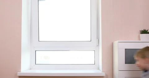 Kid boy climbs on the windowsill Stock Footage 96213108