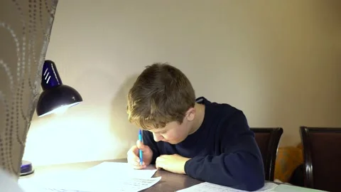 Kid boy doing homework at the table. Stock Footage 130661549