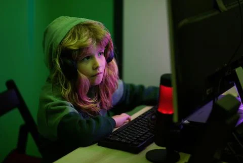 Kid boy hacker, young programmer. Child playing computer games or studying on pc Stock Photos