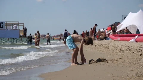 Kid boy has fun play build with a sand - happy healthy laisure on the sea Stock Footage 80870939