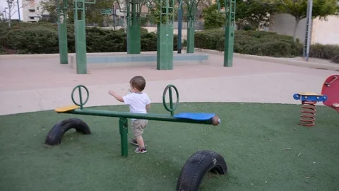 Kid boy having fun to play on children toy playground Video stock 112230464