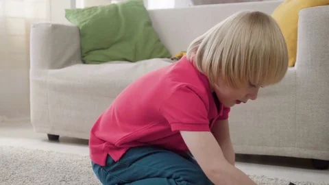 Kid boy imitates engineer constructing a building using colorful meccano Stock Footage 78298540