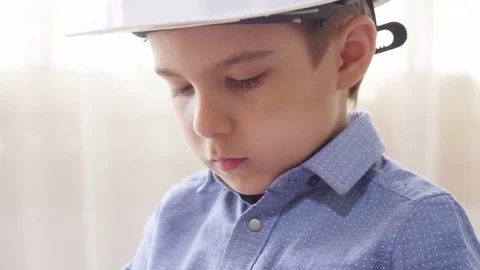 Kid boy imitates engineer constructing a building using colorful meccano Stock Footage 78708708