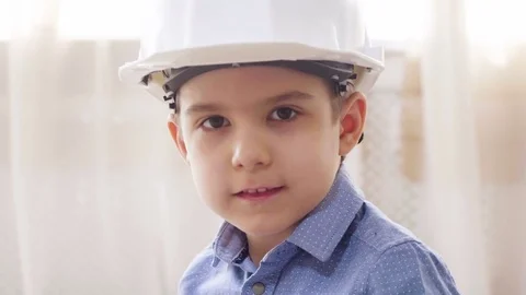 Kid boy imitates engineer constructing a building using colorful meccano Stock Footage 78708747