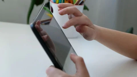 Kid boy learning or playing on computer tablet pc, distance education concept Stock Footage 128976290