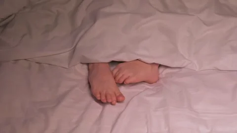 Kid boy legs itching and scabies in bed in the bedroom in the evening. Restless Stock Footage 263986537
