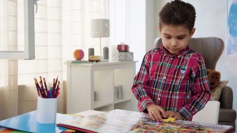 Kid boy look and examine book with color pictures with interest and fantasy Video stock 78201671