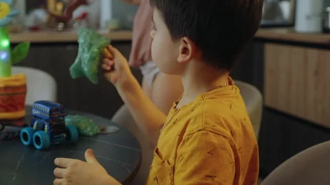 Kid boy playing with green slime. Slime in children hands. Having fun at home. Stock Footage 269348161