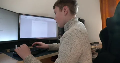 Kid Boy Use Desktop Computer for Study Typing and Reading. 4K 10-bit Stock Footage 336672808